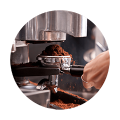 Freshly ground coffee being prepared with a commercial espresso grinder for rich and consistent espresso extraction.