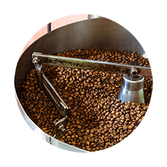Fresh coffee beans roasting inside a commercial coffee roaster for rich aroma and balanced flavor development.
