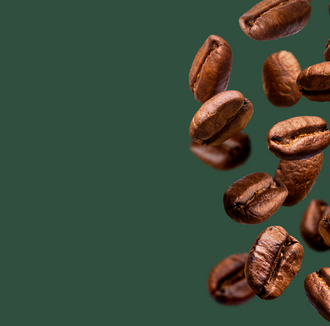 Roasted coffee beans falling on a green background, representing fresh specialty coffee and premium whole coffee beans.