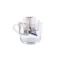 Coffee drip bag attached to a clear glass mug for easy single-cup pour over coffee brewing at home or the office.
