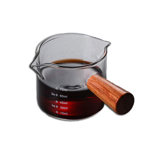 A clear glass coffee cup with a brown handle and measurement markings, filled with coffee.