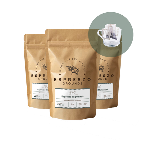 Two packages of Espreszo Highlands coffee grounds with a close-up of a coffee filter on a white background.